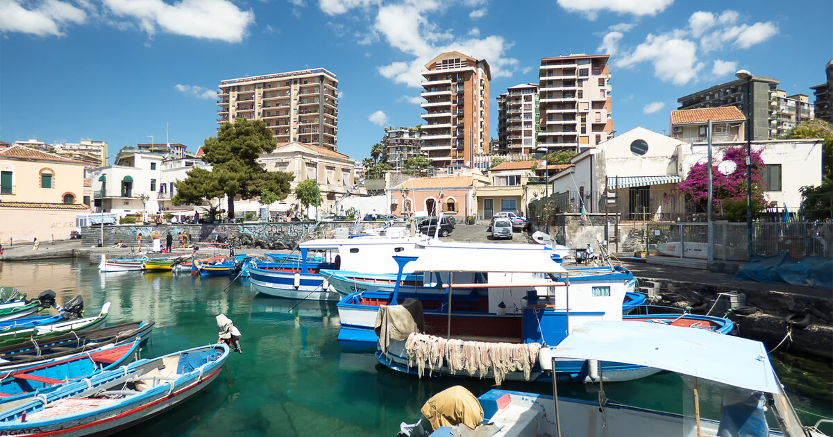 The cove of San Giovanni Li Cuti in Catania, with colourful fishing boats