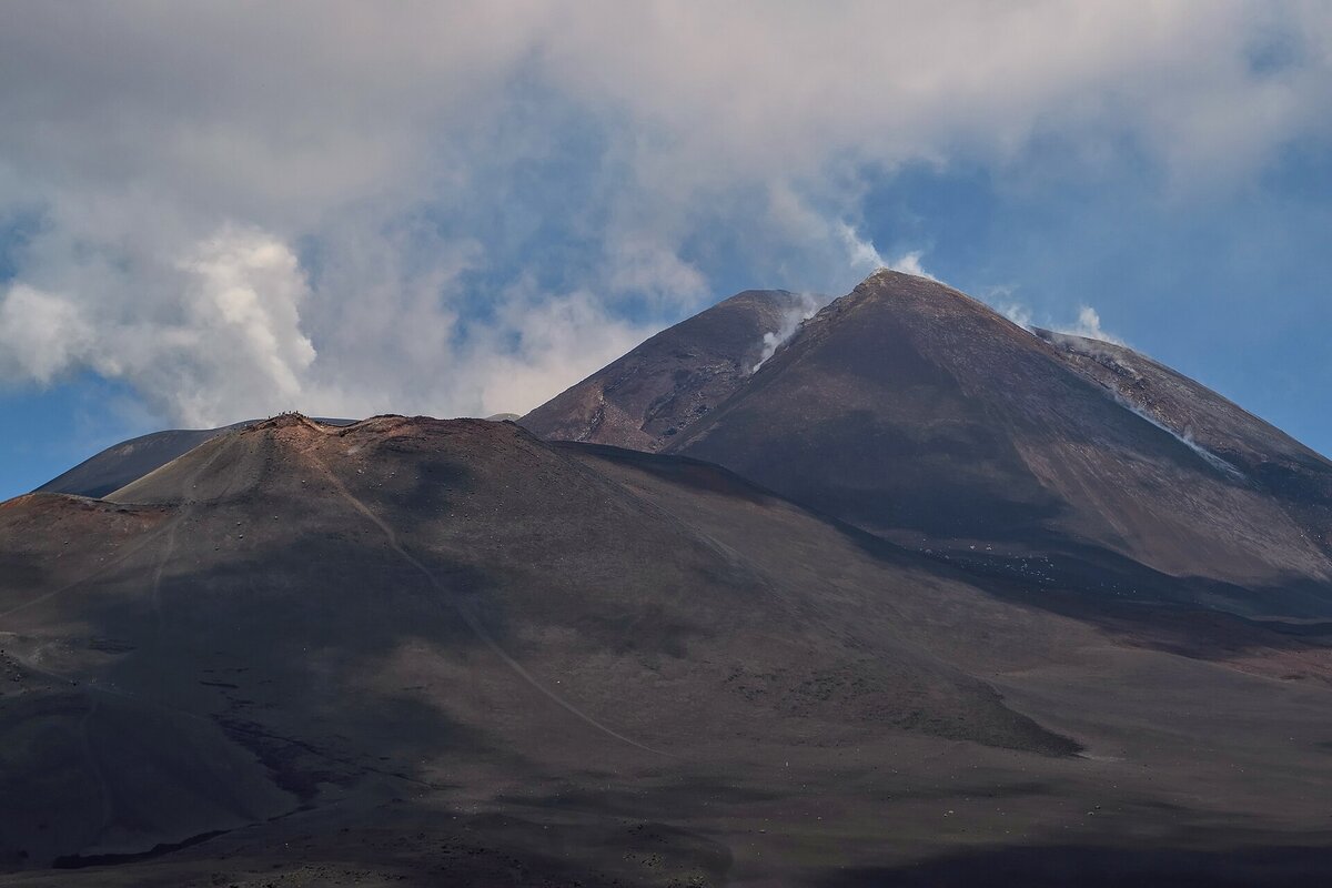 The smoking summit crater of Etna above Catania