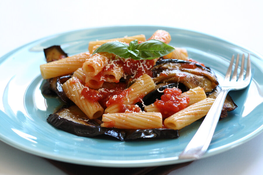 A plate of pasta alla Norma with fried aubergine and salted ricotta
