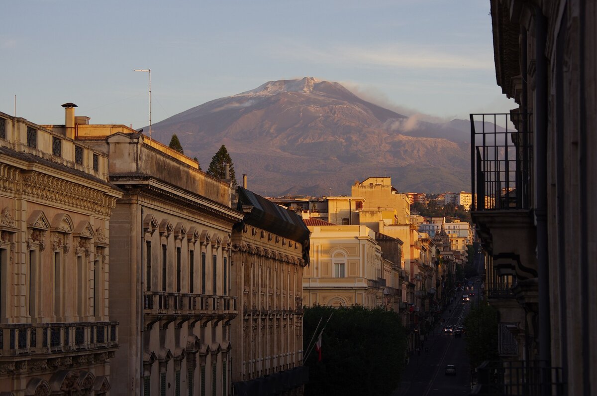 Via Etnea in Catania with snow-capped Etna in the background