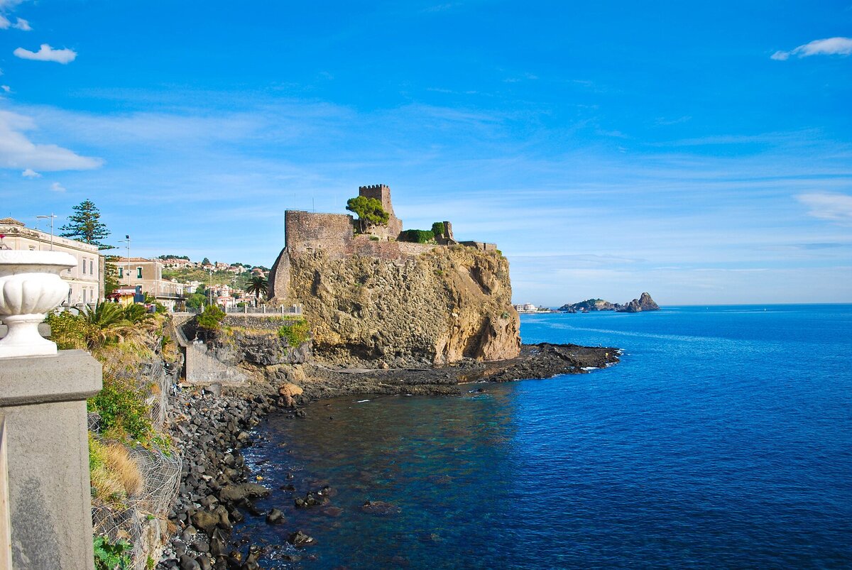 The Norman castle of Aci Castello above the lava sea
